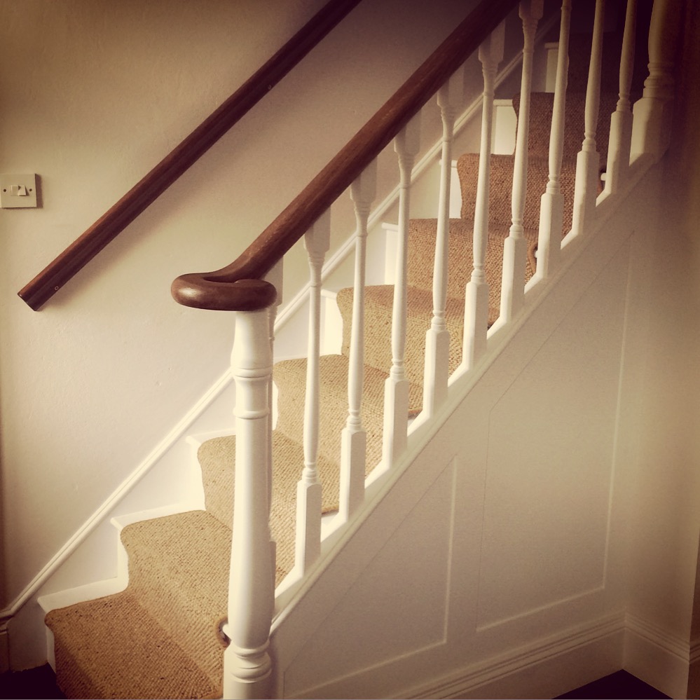 Walnut newel with white painted spindles
